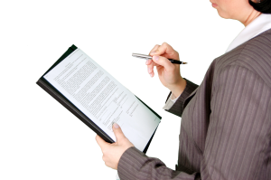 Woman holding clip board with paper and pencil