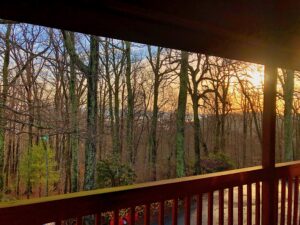 Sunrise fall view from top of mountain of mountains in the distance, it's fall and the leaves have fallen, on balcony.